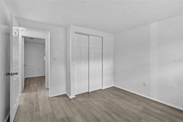 1116 Jadewood Ave, Clearwater, FL 33759 - unfurnished bedroom with wood finished floors and a closet