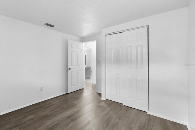 1116 Jadewood Ave, Clearwater, FL 33759 - unfurnished bedroom with wood finished floors and a closet