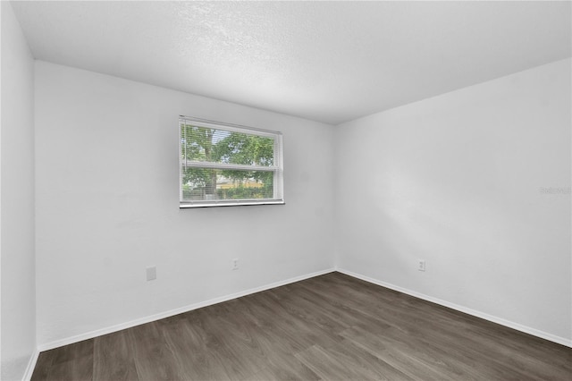 1116 Jadewood Ave, Clearwater, FL 33759 - empty room featuring dark wood-style floors and baseboards