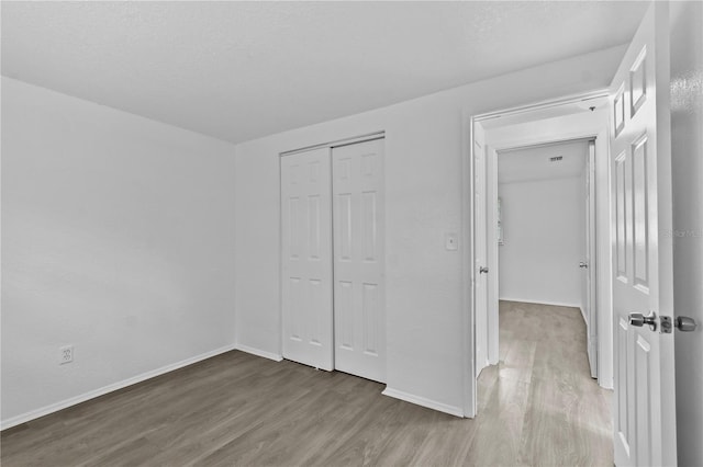 1116 Jadewood Ave, Clearwater, FL 33759 - unfurnished bedroom with wood finished floors and a closet