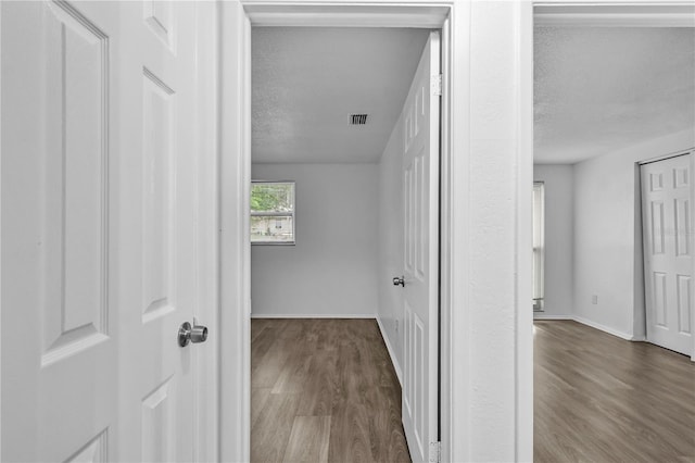1116 Jadewood Ave, Clearwater, FL 33759 - hall featuring a textured ceiling and wood finished floors