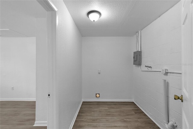 1116 Jadewood Ave, Clearwater, FL 33759 - laundry room with a textured ceiling, electric panel, and wood finished floors