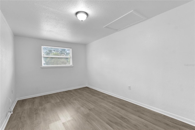 1116 Jadewood Ave, Clearwater, FL 33759 - unfurnished room with a textured ceiling and wood finished floors