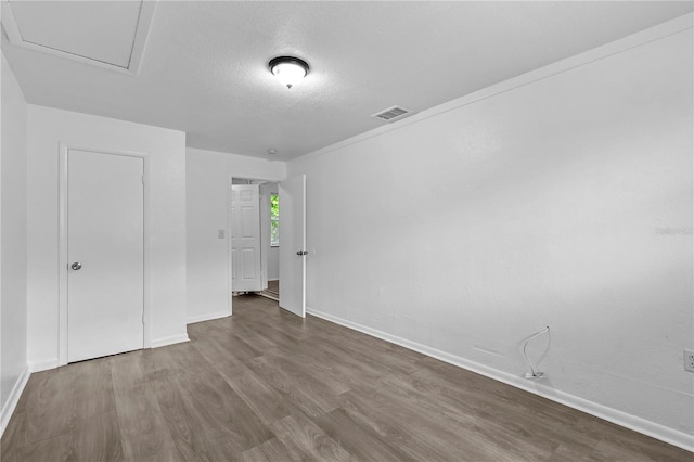 1116 Jadewood Ave, Clearwater, FL 33759 - unfurnished bedroom with wood finished floors and a textured ceiling