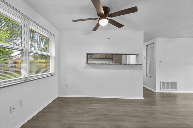 1116 Jadewood Ave, Clearwater, FL 33759 - unfurnished living room featuring a ceiling fan and dark wood-style floors