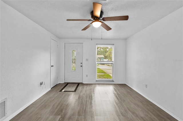 1116 Jadewood Ave, Clearwater, FL 33759 - entryway with wood finished floors, ceiling fan, and a textured ceiling