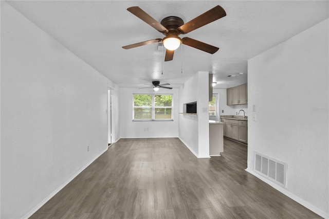1116 Jadewood Ave, Clearwater, FL 33759 - unfurnished living room featuring dark wood-type flooring and ceiling fan