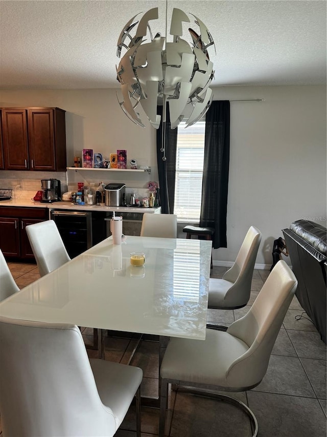 10108 Rosemary Leaf Ln, Riverview, FL 33578 - dining space with beverage cooler, tile patterned flooring, and a textured ceiling