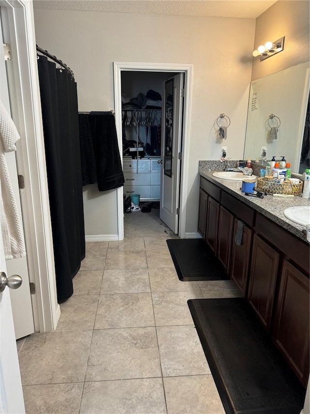 10108 Rosemary Leaf Ln, Riverview, FL 33578 - full bathroom featuring double vanity, a spacious closet, tile patterned floors, and curtained shower