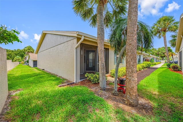 2131 Ridge Rd S Unit 19, Largo, FL 33778 - view of side of property featuring a lawn and stucco siding