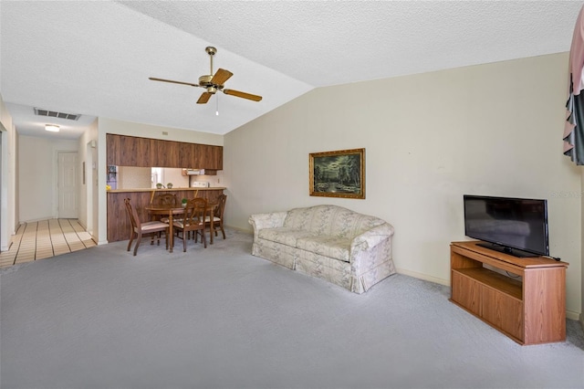 2131 Ridge Rd S Unit 19, Largo, FL 33778 - living room with lofted ceiling, ceiling fan, and light carpet