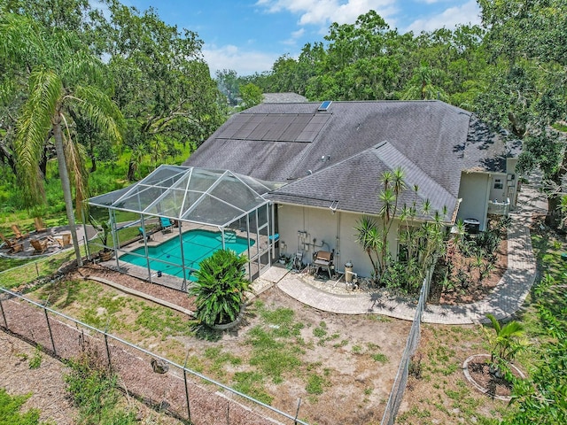 8711 Crescent Forest Blvd, New Port Richey, FL 34654 - back of property with stucco siding, a shingled roof, an outdoor pool, a patio area, and a lanai