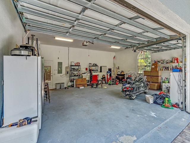 8711 Crescent Forest Blvd, New Port Richey, FL 34654 - garage with freestanding refrigerator, a garage door opener, and electric panel