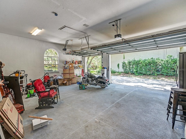 8711 Crescent Forest Blvd, New Port Richey, FL 34654 - garage featuring a garage door opener and refrigerator