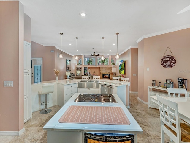 8711 Crescent Forest Blvd, New Port Richey, FL 34654 - kitchen featuring ceiling fan, ornamental molding, a peninsula, electric stovetop, and hanging light fixtures