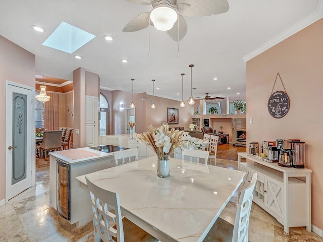 8711 Crescent Forest Blvd, New Port Richey, FL 34654 - dining area with a ceiling fan, crown molding, a skylight, beverage cooler, and recessed lighting