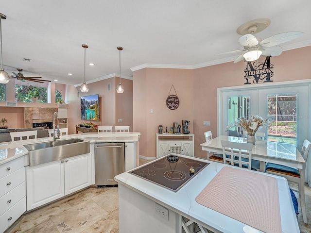 8711 Crescent Forest Blvd, New Port Richey, FL 34654 - kitchen featuring a ceiling fan, black electric stovetop, crown molding, a fireplace, and white cabinetry