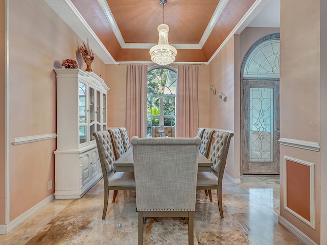 8711 Crescent Forest Blvd, New Port Richey, FL 34654 - dining room featuring a tray ceiling, crown molding, and a chandelier
