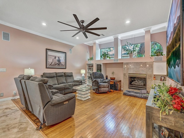8711 Crescent Forest Blvd, New Port Richey, FL 34654 - living room featuring crown molding, a fireplace, a ceiling fan, wood-type flooring, and recessed lighting