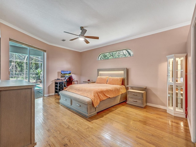8711 Crescent Forest Blvd, New Port Richey, FL 34654 - bedroom featuring access to exterior, light wood finished floors, crown molding, a ceiling fan, and a textured ceiling