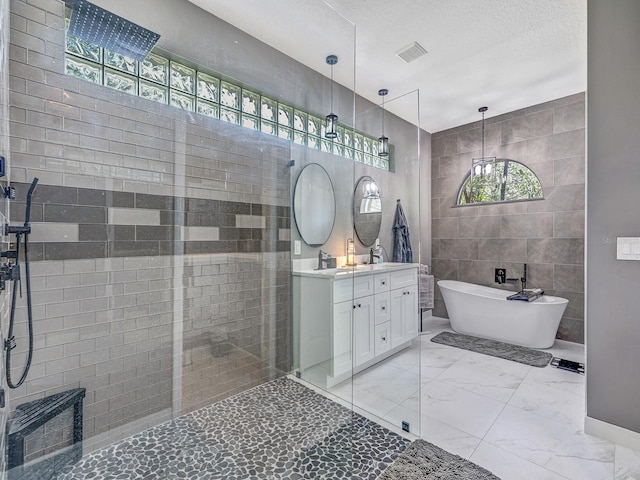 8711 Crescent Forest Blvd, New Port Richey, FL 34654 - full bathroom featuring tile walls, double vanity, a freestanding tub, walk in shower, and marble finish flooring