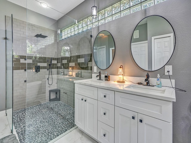 8711 Crescent Forest Blvd, New Port Richey, FL 34654 - full bathroom with marble finish flooring, double vanity, a tile shower, and a textured wall
