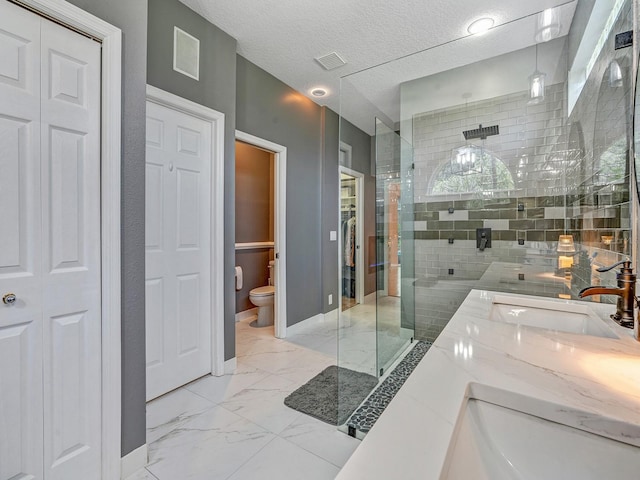 8711 Crescent Forest Blvd, New Port Richey, FL 34654 - full bathroom featuring a closet, a shower stall, double vanity, marble look tiles, and a textured ceiling