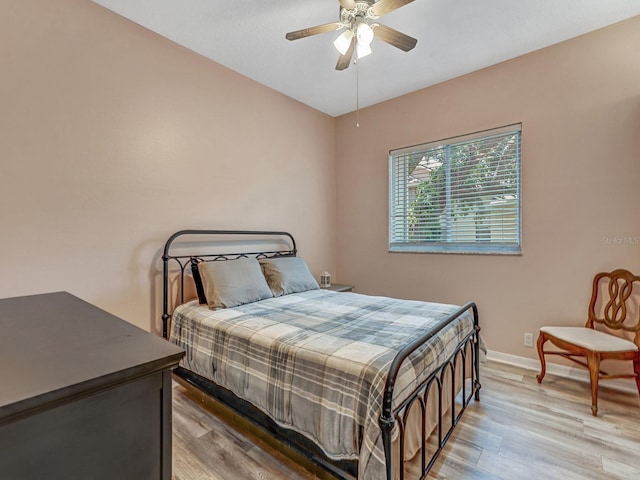 8711 Crescent Forest Blvd, New Port Richey, FL 34654 - bedroom with light wood-style flooring and ceiling fan