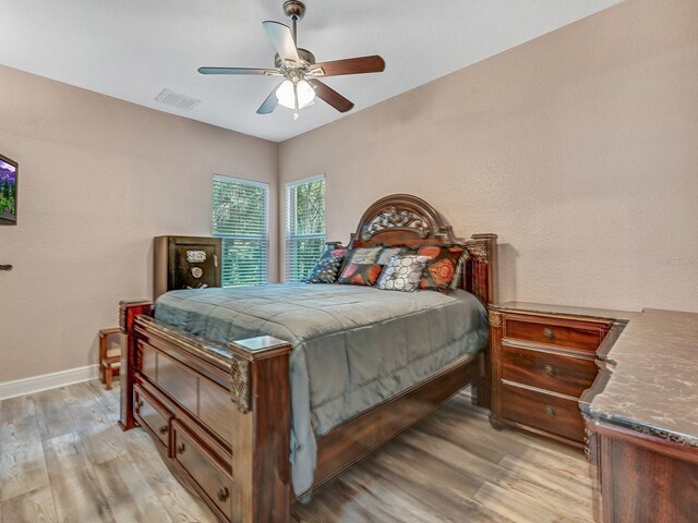 8711 Crescent Forest Blvd, New Port Richey, FL 34654 - bedroom featuring light wood-style floors and a ceiling fan