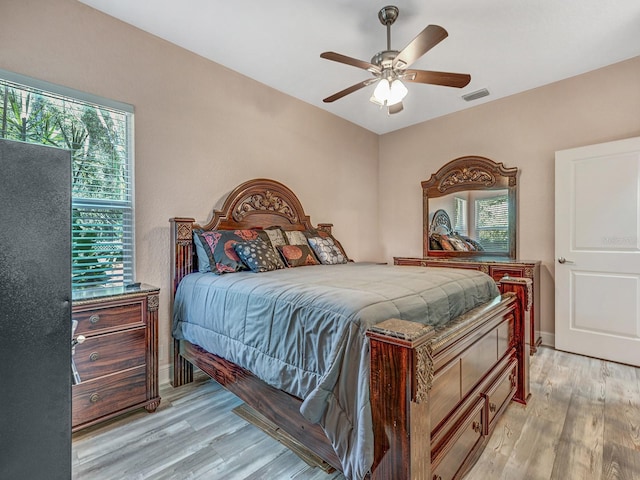 8711 Crescent Forest Blvd, New Port Richey, FL 34654 - bedroom featuring light wood finished floors and ceiling fan