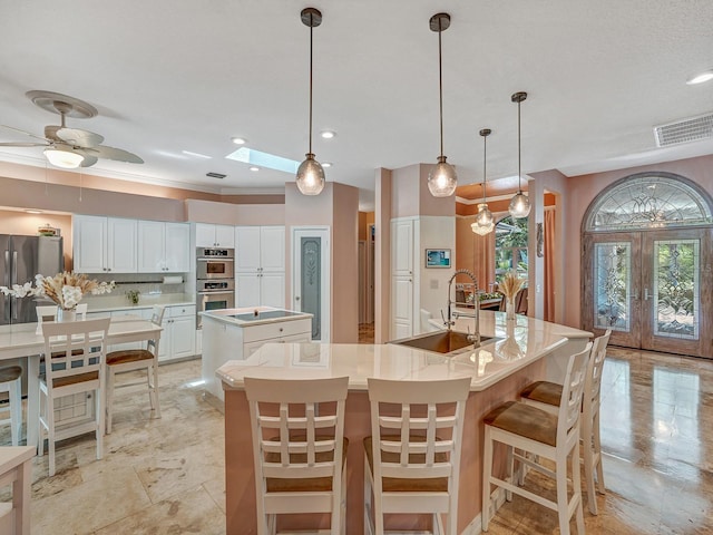 8711 Crescent Forest Blvd, New Port Richey, FL 34654 - kitchen with a spacious island, french doors, double oven, tasteful backsplash, and light countertops