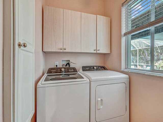 8711 Crescent Forest Blvd, New Port Richey, FL 34654 - laundry area with cabinet space and washer and clothes dryer