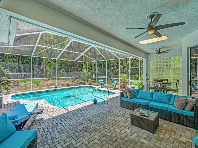 8711 Crescent Forest Blvd, New Port Richey, FL 34654 - view of pool featuring outdoor lounge area, a patio area, a ceiling fan, and glass enclosure