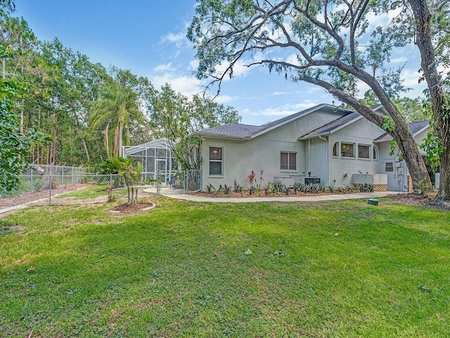 8711 Crescent Forest Blvd, New Port Richey, FL 34654 - rear view of house with stucco siding and glass enclosure