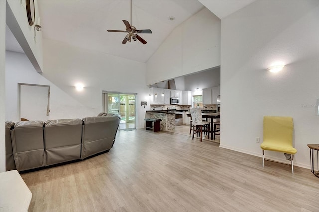 9041 58th St N, Pinellas Park, FL 33782 - living area with high vaulted ceiling, ceiling fan, and light wood-style floors