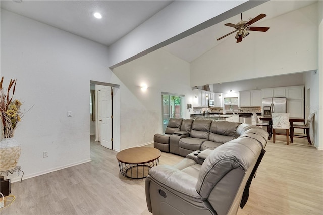 9041 58th St N, Pinellas Park, FL 33782 - living room with high vaulted ceiling, ceiling fan, and light wood-type flooring