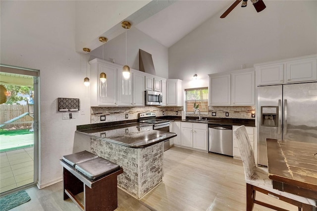 9041 58th St N, Pinellas Park, FL 33782 - kitchen featuring stainless steel appliances, high vaulted ceiling, dark countertops, a peninsula, and tasteful backsplash