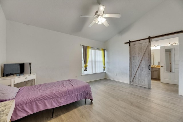9041 58th St N, Pinellas Park, FL 33782 - bedroom featuring a barn door, light wood-type flooring, a ceiling fan, high vaulted ceiling, and connected bathroom