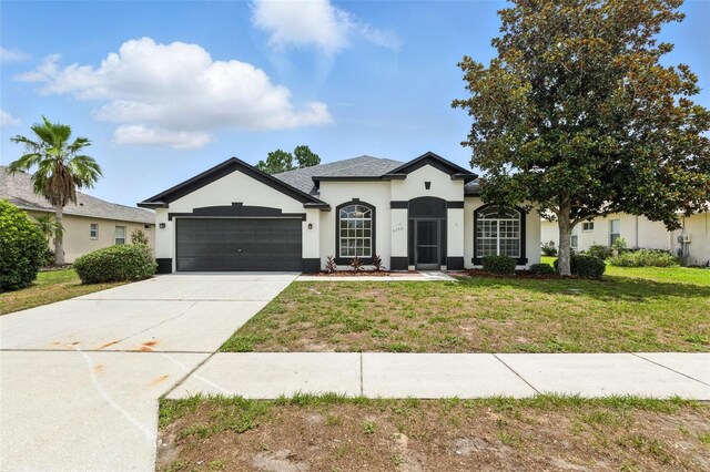 5390 Greystone Dr, Spring Hill, FL 34609 - view of front of house with stucco siding, an attached garage, a front yard, and concrete driveway