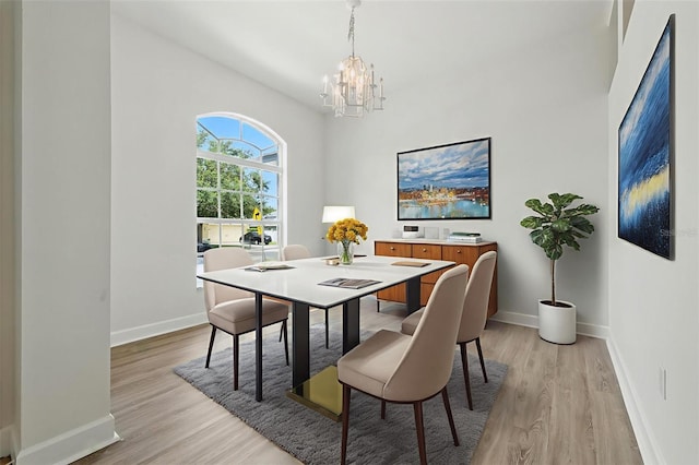 5390 Greystone Dr, Spring Hill, FL 34609 - dining area featuring a chandelier and light wood-type flooring