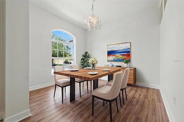 5390 Greystone Dr, Spring Hill, FL 34609 - dining room featuring a chandelier and wood finished floors