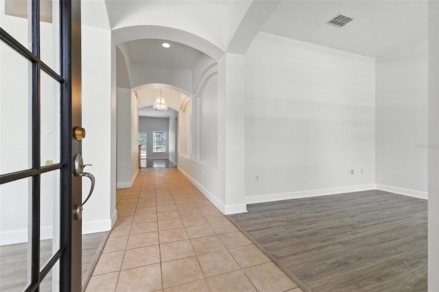 5390 Greystone Dr, Spring Hill, FL 34609 - foyer entrance with arched walkways, light tile patterned flooring, and recessed lighting