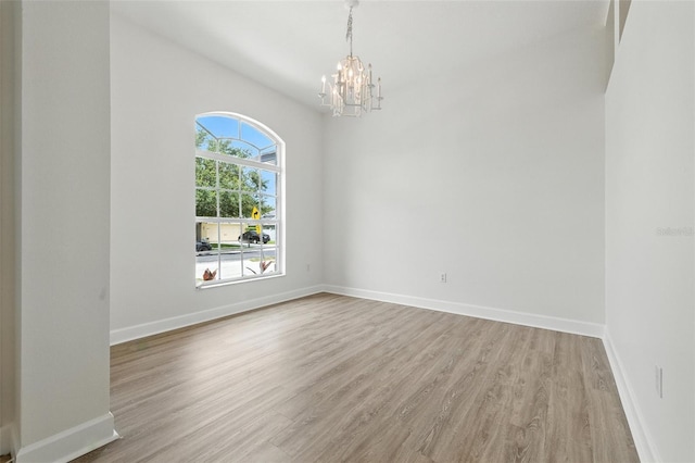 5390 Greystone Dr, Spring Hill, FL 34609 - spare room featuring a chandelier and wood finished floors