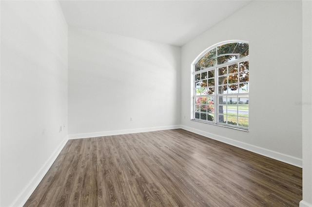 5390 Greystone Dr, Spring Hill, FL 34609 - empty room with dark wood-style floors and vaulted ceiling