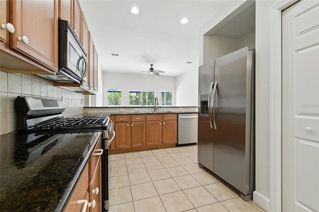 5390 Greystone Dr, Spring Hill, FL 34609 - kitchen with appliances with stainless steel finishes, brown cabinets, tasteful backsplash, a ceiling fan, and recessed lighting