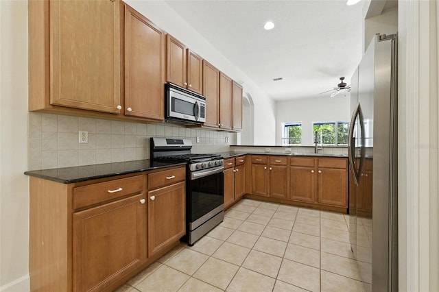 5390 Greystone Dr, Spring Hill, FL 34609 - kitchen featuring appliances with stainless steel finishes, tasteful backsplash, a ceiling fan, brown cabinetry, and recessed lighting