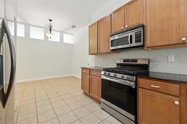 5390 Greystone Dr, Spring Hill, FL 34609 - kitchen featuring stainless steel appliances, backsplash, brown cabinetry, and light tile patterned floors