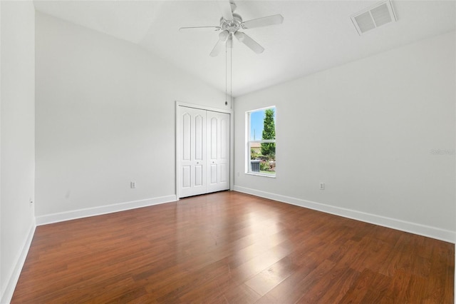 5390 Greystone Dr, Spring Hill, FL 34609 - unfurnished bedroom featuring a closet, lofted ceiling, dark wood-style flooring, and a ceiling fan