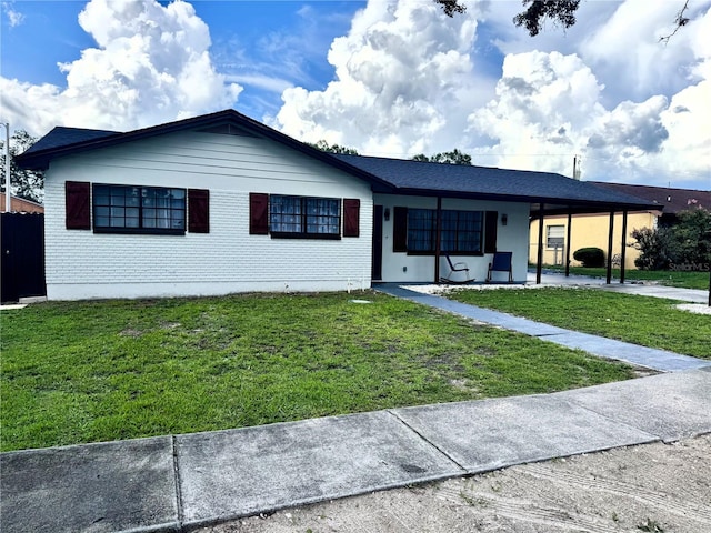 2509 Thornbrook Pl, Tampa, FL 33618 - ranch-style house with a front lawn and a carport