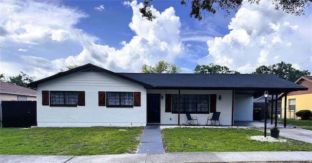 2509 Thornbrook Pl, Tampa, FL 33618 - single story home featuring a porch, a carport, and concrete driveway
